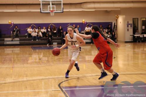Kelsey Johnson drives to the rim in a conference game earlier this year against Coast Guard Academy  (courtesy: Emerson Channel Sports)